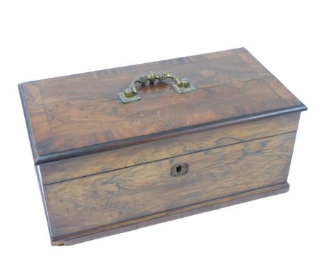 A late Georgian rosewood tea caddy, of rectangular section, with a brass handle, the hinged lid opening to reveal two lidded 