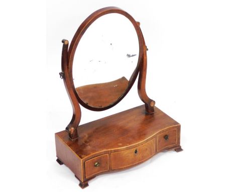 A George III mahogany swing frame toilet mirror, the oval mirror raised on a serpentine base with three drawers, raised on br