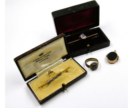 9ct Gold Royal Artillery bar brooch in a original box, together with another yellow metal bar brooch, set with an uncut gemst
