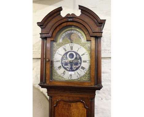 George III oak and pollard oak longcase clock with mahogany crossbanding and quarter pilasters, the broken arch hood above an