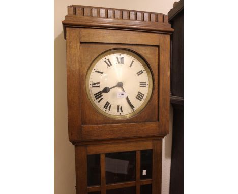 Early to mid 20th Century oak longcase clock, the circular silvered dial with Roman numerals and three train weight driven mo