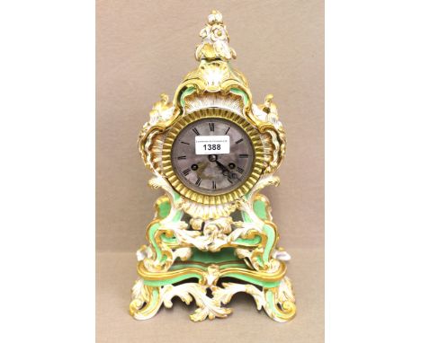 19th Century French porcelain mantel clock having gilt and hand painted floral decoration on a white and green ground, the ci