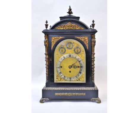 Edwardian ebonised and gilt brass mounted musical bracket clock, the broken arch case with five finial surmount and canted co