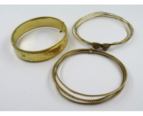 Two yellow metal bangles, 24g, together with a rolled gold bangle 