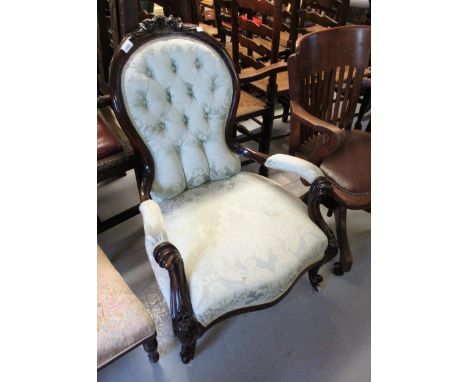 19th Century mahogany spoon back open armchair having green damask button upholstered back, overstuffed seat, raised on cabri