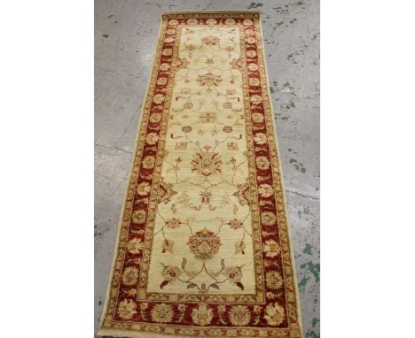 Indo Persian runner of Ziegler design with a palmette pattern on an ivory ground with borders, 249cms x 80cms 