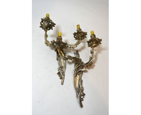 Pair of silvered metal twin branch wall lights, three wrought iron candle sconces, various brass candlesticks, a table lamp a