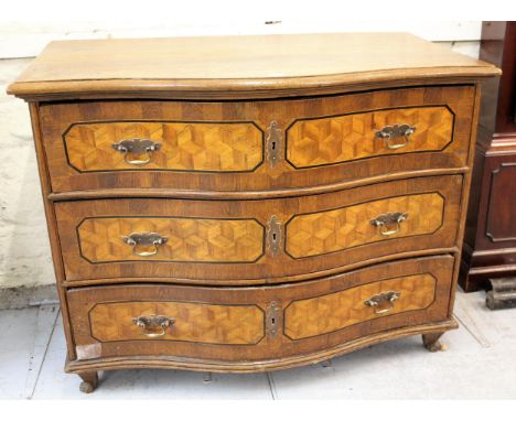 18th Century oak serpentine fronted commode chest of three drawers and geometric design panels, with brass swan neck handles 