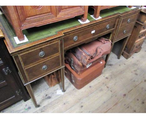 Edwardian mahogany boxwood and ivorine line inlaid inverted breakfront writing desk, the green leather inset top above five d