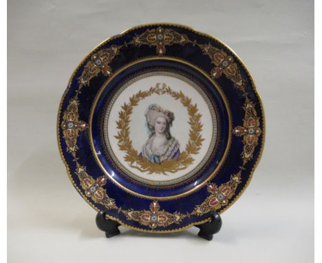 19th Century French porcelain plate, painted with a portrait of a lady within a dark blue and gilt border, bearing Sevres mar