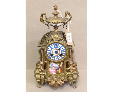 19th Century French gilt metal, porcelain mounted mantel clock, surmounted with an urn above a circular dial with floral deco