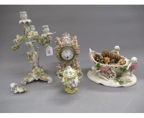Continental porcelain and floral encrusted four light candelabra (at fault), 34cms high together with a vase in the form of p