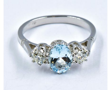 Platinum three stone claw set aquamarine and diamond ring, size 'O' 