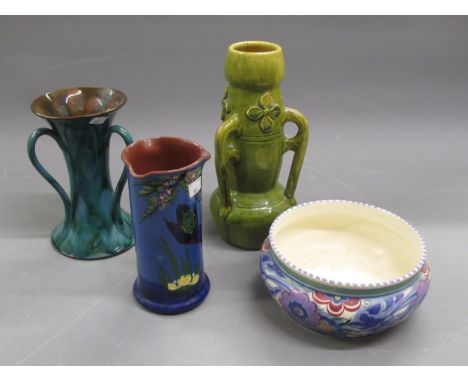 Poole pottery floral decorated low bowl, green glazed pottery vase with three handles and two Torquay pottery vases 