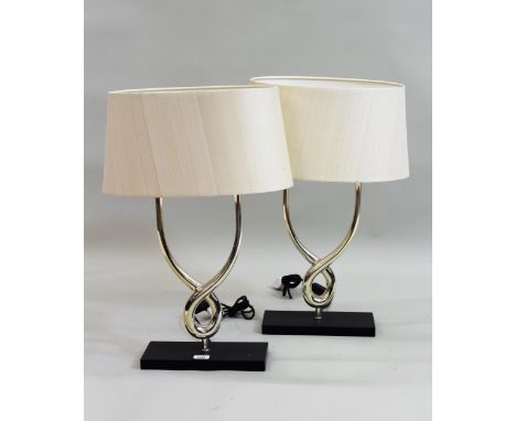 Pair of Porta Romana silvered metal twin light table lamps, of stylised design with rectangular plinth bases and original ova