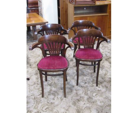 A set of four stained beechwood framed Bentwood cafe chairs with upholstered pad seats and pierced comb splats
