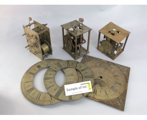 A number of 18th century and later brass longcase clock dials, two Georgian 30 hour brass clock movements and other spares