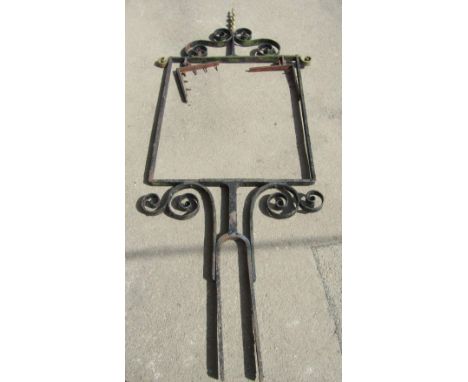 A large wrought iron exterior sign frame with scroll work detail and spiral finial, 254cm high x 108cm wide approx at widest 