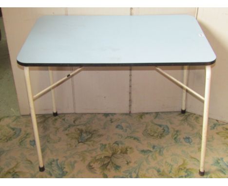 A small 1950s kitchen table of rectangular form with rounded corners and light blue formica top raised on painted tubular leg