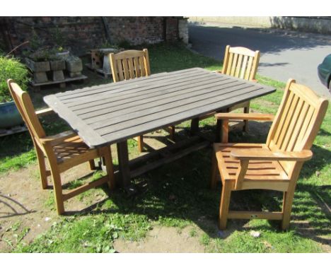 A Swan Hattersley weathered teak garden table, the rectangular slatted top raised on square cut supports and sledge feet unit