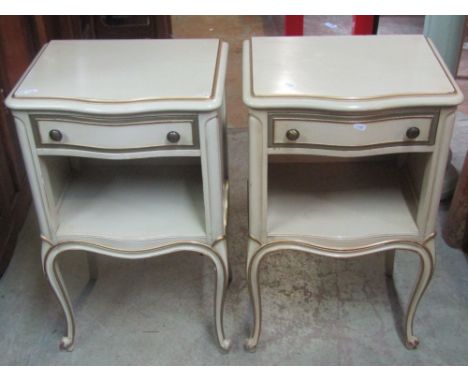 A pair of reproduction light green painted bedside lamp tables, the serpentine front fitted with a frieze drawer, over an ope