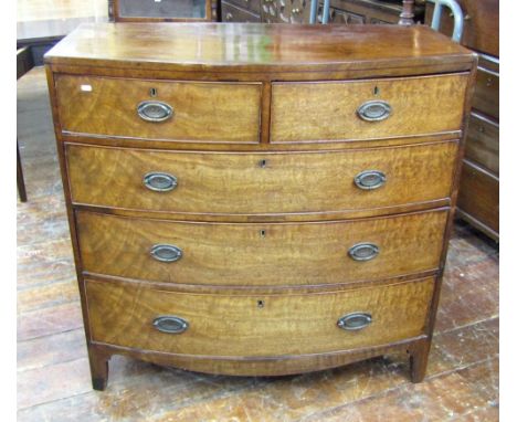 A Regency mahogany bow fronted chest of three long and two short drawers with caddy top, crossbanded and string inlay detail 