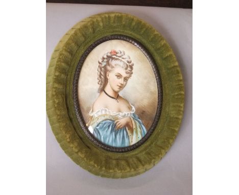 An oval miniature portrait showing a lady in late 18th century style costume, indistinctly signed, 12cm max oval, in green ve