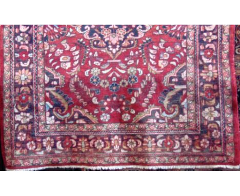 Persian Hammerdan rug with central dark floral medallion and further floral sprays upon a red ground, 200 x 165 cm 