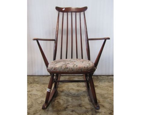 A vintage dark stained Ercol Windsor stickback armchair with stained beechwood frame, together with a further Ercol dark stai