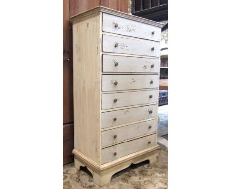A hardwood bedroom chest of eight long drawers with button handles and all over painted and distressed finish, 76 cm wide x 4