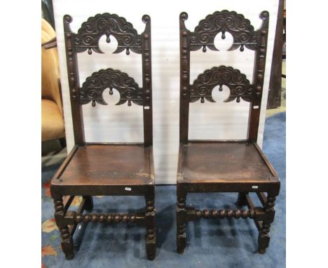 A pair of Yorkshire ladderback jointed back stools with geometric carved detail, solid seats raised on turned bobbin moulded 