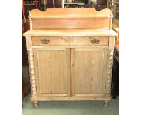 A Victorian stripped pine chiffonier, the shallow raised back with shaped outline supporting a shelf with turned bobbin suppo