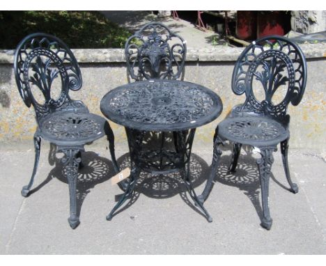 A Victorian style painted cast aluminium garden terrace table of circular form with decorative pierced top raised on swept tr