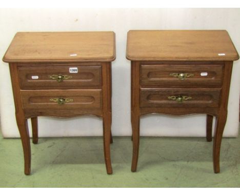 A pair of low oak two drawer bedside lamp tables with moulded detail raised on square tapered and slightly swept supports