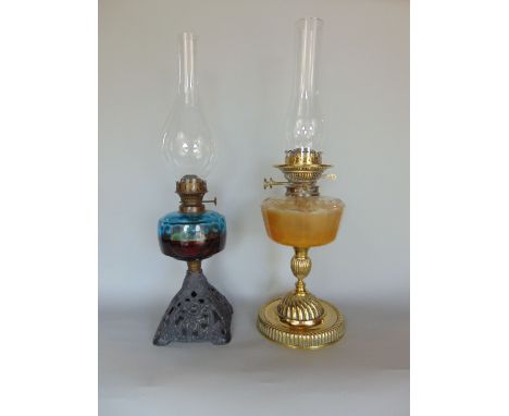 A good quality cast brass oil lamp with faceted glass reservoir upon a fluted baluster column, with stepped circular base, th