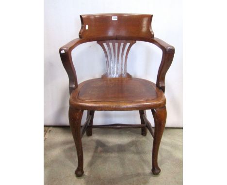 Edwardian oak bow back office chair with pierced comb splat over a solid panelled seat and cabriole forelegs united by stretc