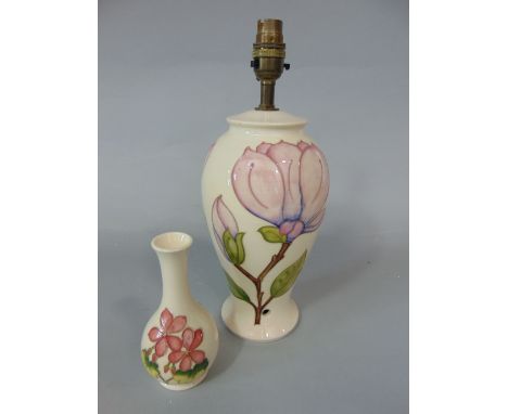 A cream ground Moorcroft table lamp base with magnolia decoration and impressed marks to base, 27cm approx excluding fittings