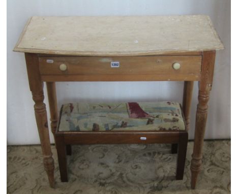 A Victorian stripped pine side table, the, possibly associated, bow fronted overhanging top over a frieze drawer and turned s