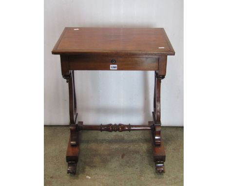 A Victorian mahogany sewing/work table of rectangular form with moulded outline over a frieze drawer raised on a pair of pier