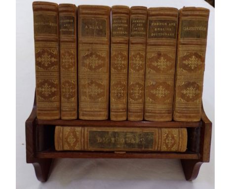 An Asprey &amp; Co Reference Library in a mahogany rest with an Asprey's stamp to the back, containing eight leather bound bo