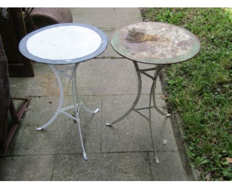 A pair of vintage steel bistro/lamp tables, the swept tripod supports supporting circular painted tin tops