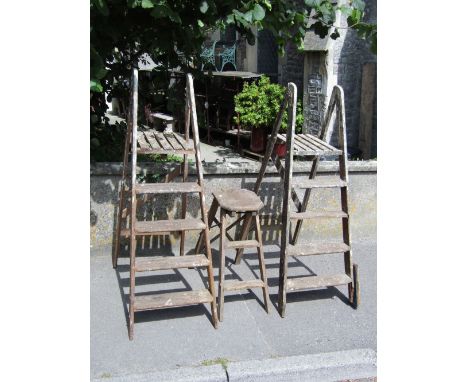 Two vintage pine folding step ladders together with a further folding work stool with elm seat (to be sold for display purpos