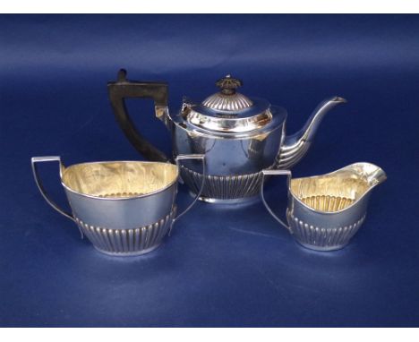 Late Victorian Georgian style silver three piece bachelor tea service, with half fluted decoration, comprising tea pot, milk 