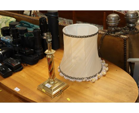 A brass table lamp and shade