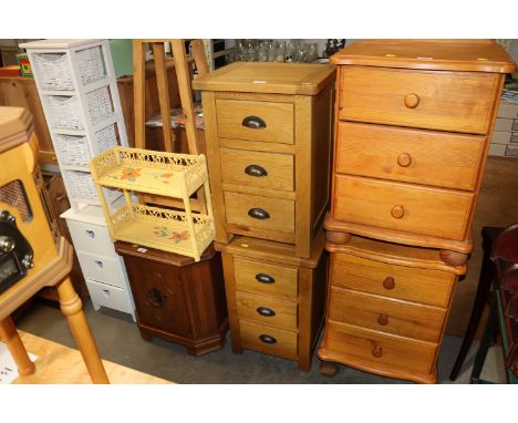 A pair of light oak bedside chests each fitted three drawers