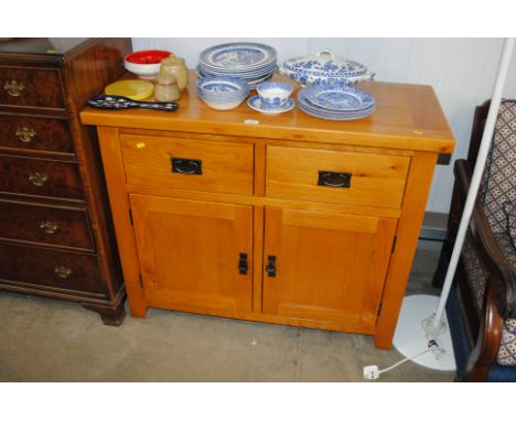 A modern light oak sideboard fitted two drawers