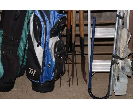 A quantity of wooden handled tools to include pitch fork, two slashers etc.