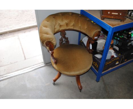 A carved oak button back upholstered swivel tub chair