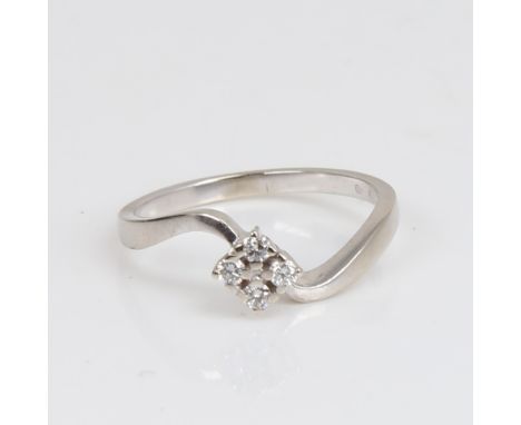 A modern 18ct gold diamond cluster crossover ring, set with modern round brilliant-cut diamonds, total diamond content approx