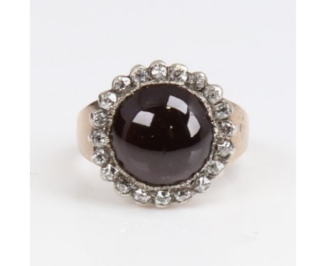 An Antique unmarked gold cabochon garnet and diamond cluster ring, set with round cabochon foil-back garnet surrounded by old